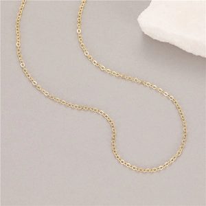 Minimalist 1.5mm golden stainless steel thin cable chain necklace on grey background