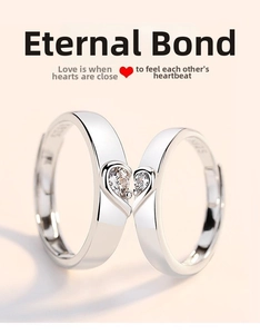 Detail of silver couple rings with S925 engraving and heart shaped zircon center