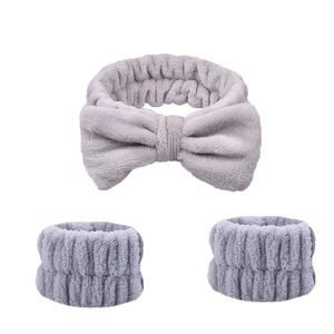 Three-piece set of gray plush bow headband and wristbands in soft coral fleece fabric