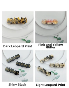 Detail of four colorful acetate cat hair clips showing textures and gold printing