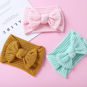 Set of 3 knitted waffle fabric baby headbands with large bows in pink, yellow and green