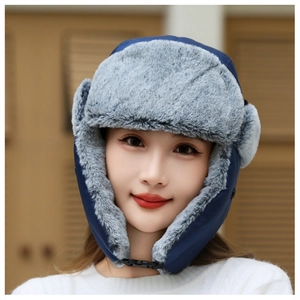 Detail of navy blue winter trapper hat featuring warm gray faux fur lining and chin strap