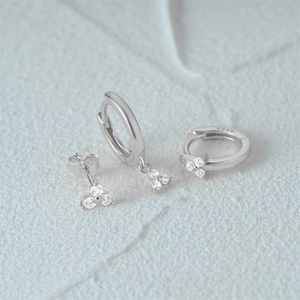 Detailed macro view of S925 silver earring set with cubic zirconia on white stone