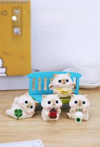 Detailed view of four cute lucky cat figurines with miniature clover and soda accessories