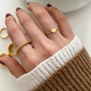 925 Sterling Silver bear ring set with gold twist bands on a model's hand