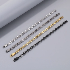 Detail of O-shaped chain bracelets in silver, gunmetal, gold, and black with lobster clasps