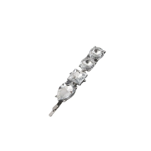 Detailed macro view of silver hair pin with round square and teardrop crystals