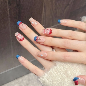 Unghie finte con motivi a ciliegia, perle e glitter blu su unghie quadrate medie