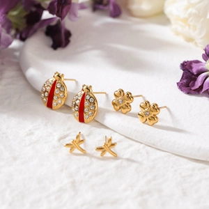 Three-pair gold stainless steel insect earring set with red enamel ladybug and clover designs