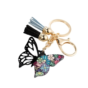 Cute acrylic butterfly keychain with colorful floral patterns and tassels on white background