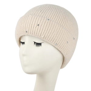 Close-up of cream knit beanie featuring elegant pearl and rhinestone embellishments