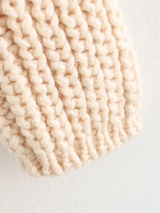 Chunky knit crewneck cardigan in beige featuring soft texture and detailed weave patterns