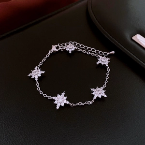 Detailed macro view of the silver star flower bracelet with sparkling cubic zirconia charms