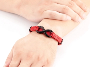 Close-up of red leather bracelet for men with black infinity symbol on model's wrist