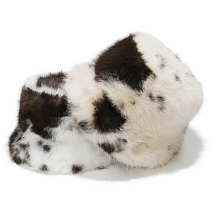 Winter faux fur bucket hat with black and white cow print and plush warm texture