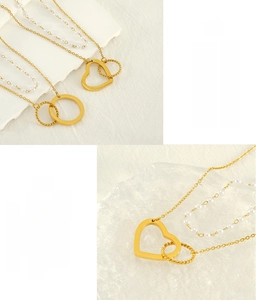 Detail of double-layer stainless steel pearl necklace with hollow heart and ring pendant