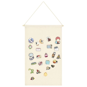 Detail of beige canvas banner with wooden rod for displaying pin badges and brooches
