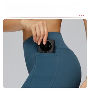 Detail showing side pocket of dark blue high-waisted yoga pants holding a phone