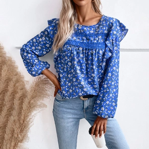 Blue floral long sleeve blouse with lace patchwork and ruffled details on white background
