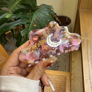 Chic pink acetate cloud-shaped hair claw with moon rhinestones and moon lettering