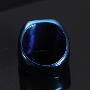 Macro shot of wide 18mm blue stainless steel band ring with brushed metal texture
