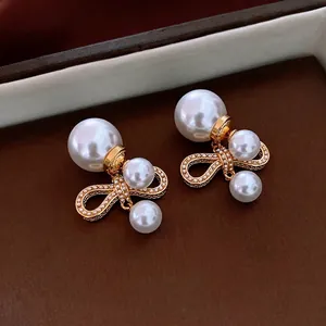 Elegant gold-plated bow pearl drop earrings with luxury vintage aesthetic for women