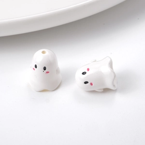 Close-up of white acrylic cartoon ghost beads with pink cheeks for DIY jewelry making