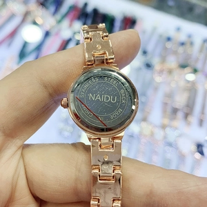 Macro shot of NAIDU women's quartz watch showing stainless steel back with engraved logo