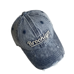 Distressed wash denim baseball cap featuring Brooklyn embroidery and vintage rip details