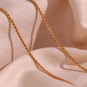 Minimalist 18K gold plated stainless steel box chain necklace for women on silk background