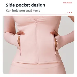Pink fitness jacket detail showing secure side zipper pockets and quick-dry fabric texture