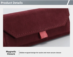 Close-up of wine red velvet glasses case with magnetic closure and pink pull tab detail