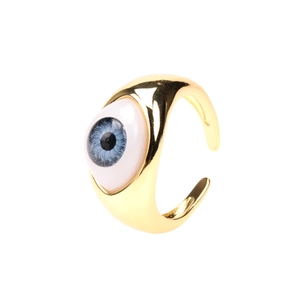 Detailed close-up of a gold adjustable open ring featuring a blue resin evil eye design