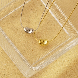 Minimalist bean pendant snake chain necklace set in polished gold and silver finish