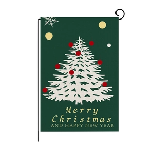 Detail of Christmas garden flag with white tree on green linen fabric with metal stand