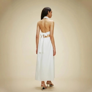 Detail of the backless halter dress showing the elegant white bow tie and open back design