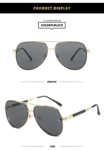 Detail view of golden aviator sunglasses with black lenses and dual bridge design