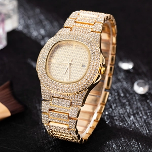 Detail shot of the luxury iced-out gold watch featuring a diamond-encrusted bezel and dial