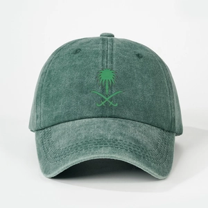 Detail of the palm tree and crossed swords emblem on the washed green baseball cap