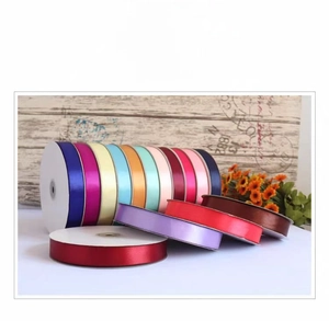 Close-up of colorful 2cm satin ribbon rolls for gift wrapping and cake decoration