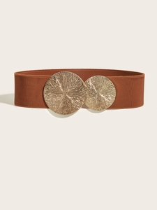 Detail of brown elastic wide belt with double circular sunburst gold metal buckle