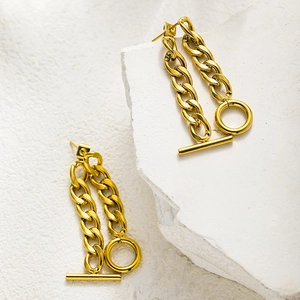 Detailed view of gold stainless steel earrings with OT toggle clasp on white stone