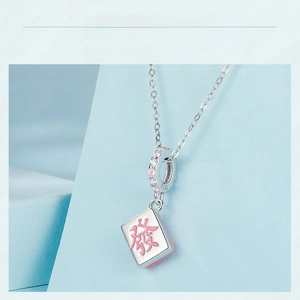 Macro view of S925 sterling silver Mahjong charm with pink enamel Fa character and zircons
