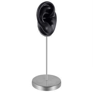 Detailed black silicone ear model on silver metal stand for jewelry earring display