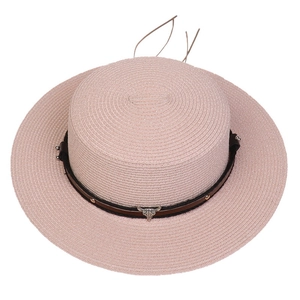 Top view of pink flat-top woven straw hat with brown leather belt and metal bull head charm