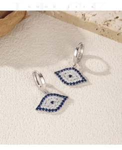 Macro shot of S925 silver blue evil eye drop earrings with sparkling rhinestones detail