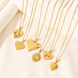 Close-up of 18k gold plated heart pendants with various textures on O-chains