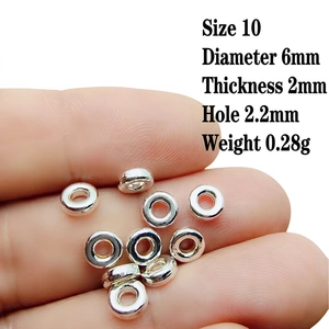 Close-up of 6mm silver alloy spacer beads for jewelry making showing size and detail