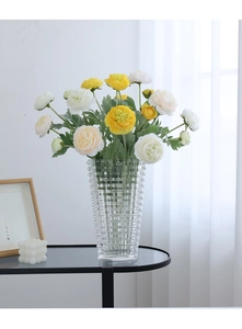 Modern geometric glass vase with realistic yellow and white peony flowers in a bright room