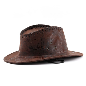 Detail of vintage brown western cowboy hat with faux leather texture and ventilation holes